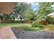 View of the expansive backyard featuring a well-kept lawn and wood fence at 14624 Pine Lake St, Clermont, FL 34711