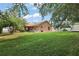 This is a large backyard with an enclosed patio and a shed in the distance at 14624 Pine Lake St, Clermont, FL 34711