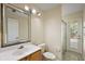 This is a bathroom with a vanity, toilet, enclosed shower, and a door to the outside at 14624 Pine Lake St, Clermont, FL 34711