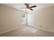 Cozy bedroom featuring tile flooring, a ceiling fan, and a double-door closet at 14624 Pine Lake St, Clermont, FL 34711