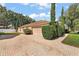 Lovely home exterior with a paved brick driveway, well-maintained landscaping, and attached two-car garage at 14624 Pine Lake St, Clermont, FL 34711