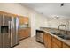 Modern kitchen with stainless steel appliances, granite countertops, and maple cabinets at 14624 Pine Lake St, Clermont, FL 34711