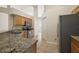 Well-lit kitchen with stainless steel appliances, granite countertops, and tile flooring at 14624 Pine Lake St, Clermont, FL 34711