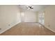 Bright living room featuring tile flooring, ceiling fan, and direct patio access at 14624 Pine Lake St, Clermont, FL 34711