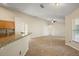 Open-concept living room features tile flooring and seamless flow into the kitchen at 14624 Pine Lake St, Clermont, FL 34711