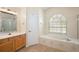 The main bathroom offers a soaking tub, and a separate tiled shower enclosure at 14624 Pine Lake St, Clermont, FL 34711