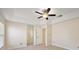 The main bedroom features tile flooring, a ceiling fan, and an en-suite bathroom at 14624 Pine Lake St, Clermont, FL 34711