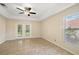 The main bedroom boasts tile flooring, patio access, and natural lighting at 14624 Pine Lake St, Clermont, FL 34711
