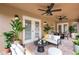 Covered patio with ceiling fans, comfortable seating, and access to the outdoors at 14624 Pine Lake St, Clermont, FL 34711