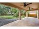 This is a covered patio with two ceiling fans and a view of the backyard at 14624 Pine Lake St, Clermont, FL 34711