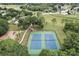 Aerial view of community tennis courts, playground and green space, for recreational activities and outdoor enjoyment at 14624 Pine Lake St, Clermont, FL 34711