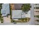 Aerial view of a home with a grey roof, an enclosed patio and a driveway with a vehicle at 16608 W Citrus Pkwy, Clermont, FL 34714