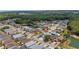 An aerial view of a neighborhood with mature trees and water features at 16608 W Citrus Pkwy, Clermont, FL 34714