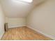 Cozy attic space with sloped ceilings, laminate flooring, and ample storage potential at 16608 W Citrus Pkwy, Clermont, FL 34714