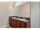 Bathroom showcasing double vanity with granite countertops, and wood cabinets at 16608 W Citrus Pkwy, Clermont, FL 34714