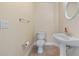 Bathroom featuring pedestal sink, toilet, and a round decorative mirror at 16608 W Citrus Pkwy, Clermont, FL 34714