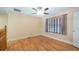 Cozy bedroom featuring hardwood floors, a ceiling fan, and a large window at 16608 W Citrus Pkwy, Clermont, FL 34714