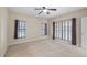 A spacious bedroom with neutral carpet and large windows with blinds at 16608 W Citrus Pkwy, Clermont, FL 34714
