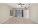 A spacious bedroom with ceiling fan and three large windows at 16608 W Citrus Pkwy, Clermont, FL 34714