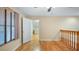 Spacious bedroom with hardwood floors, an open door, and natural light from a window at 16608 W Citrus Pkwy, Clermont, FL 34714