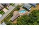 Aerial shot of a sparkling community pool with lounge chairs and a nearby clubhouse at 16608 W Citrus Pkwy, Clermont, FL 34714