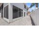 Exterior view of the home with a screened-in porch and a paved backyard at 16608 W Citrus Pkwy, Clermont, FL 34714