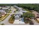 A nice two-story home with a two-car garage, a well-maintained lawn, mature trees, and a long driveway at 16608 W Citrus Pkwy, Clermont, FL 34714