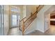 Inviting foyer with tile flooring, staircase, and decorative glass front door at 16608 W Citrus Pkwy, Clermont, FL 34714