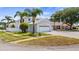 Well-maintained corner lot home with a two-car garage and lush landscaping in a tranquil neighborhood at 16608 W Citrus Pkwy, Clermont, FL 34714