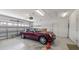 Clean and organized two-car garage with ample space and a red sports car at 16608 W Citrus Pkwy, Clermont, FL 34714