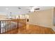 Spacious loft area featuring hardwood floors, ceiling fans, and an open view to the lower level at 16608 W Citrus Pkwy, Clermont, FL 34714