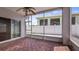 Cozy screened-in patio with wood-look flooring and ceiling fan, perfect for outdoor relaxation at 16608 W Citrus Pkwy, Clermont, FL 34714