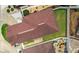 Aerial view of a home with a well-maintained roof, green lawn and landscaped backyard at 17174 Se 76Th Caledonia Ter, The Villages, FL 32162