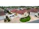 Aerial view of home in community featuring a well maintained lawn, landscaping, and driveway at 17174 Se 76Th Caledonia Ter, The Villages, FL 32162