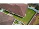 Aerial view of a home with a well-maintained roof, green lawn and landscaped backyard with privacy fence at 17174 Se 76Th Caledonia Ter, The Villages, FL 32162