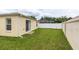 Green backyard featuring lush lawn with room for gardening and outdoor activities at 17174 Se 76Th Caledonia Ter, The Villages, FL 32162