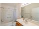 Clean bathroom with a shower-tub combination, white countertops, and wooden cabinets at 17174 Se 76Th Caledonia Ter, The Villages, FL 32162