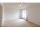 Neutral bedroom with a ceiling fan, carpet, and a window overlooking the yard at 17174 Se 76Th Caledonia Ter, The Villages, FL 32162