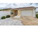 Home's exterior showcases a well-maintained lawn and driveway at 17174 Se 76Th Caledonia Ter, The Villages, FL 32162