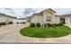 Well-manicured lawn and landscape highlight this home's exterior at 17174 Se 76Th Caledonia Ter, The Villages, FL 32162
