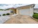 Charming single-story home featuring a two-car garage and well-maintained landscaping at 17174 Se 76Th Caledonia Ter, The Villages, FL 32162