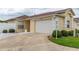 Charming single-story home featuring a two-car garage and well-maintained landscaping at 17174 Se 76Th Caledonia Ter, The Villages, FL 32162