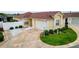 Aerial view of home showcasing its well-manicured lawn, driveway, and attached garage at 17174 Se 76Th Caledonia Ter, The Villages, FL 32162