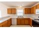 Functional kitchen with white appliances and light-colored wood cabinets at 17174 Se 76Th Caledonia Ter, The Villages, FL 32162