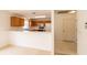 Open-concept kitchen with wood cabinets, offering a practical and inviting space for cooking and gathering at 17174 Se 76Th Caledonia Ter, The Villages, FL 32162