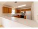 Bright kitchen with wooden cabinets, modern appliances, and ample counter space, perfect for culinary enthusiasts at 17174 Se 76Th Caledonia Ter, The Villages, FL 32162