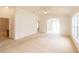 Large living room provides access to a bathroom and other rooms with lots of natural light at 17174 Se 76Th Caledonia Ter, The Villages, FL 32162