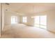 Bright, open living room with sliding glass doors and neutral carpeting, providing a welcoming space at 17174 Se 76Th Caledonia Ter, The Villages, FL 32162