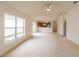 Bright living room featuring an open floor plan, neutral carpet and large windows at 17174 Se 76Th Caledonia Ter, The Villages, FL 32162