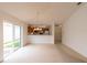 Bright living room featuring an open floor plan, neutral carpet and sliding glass doors at 17174 Se 76Th Caledonia Ter, The Villages, FL 32162